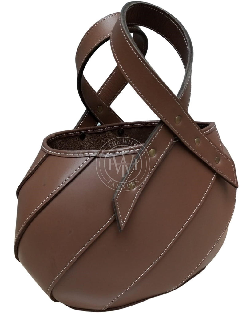 leather tote bag, brown leather bag, handmade leather handbag, luxury leather tote, stylish leather purse, bucket style leather bag, cross handle leather bag, oval base tote bag, spacious leather bag, designer leather handbag, artisan leather tote, durable leather purse, fashionable leather carryall, handcrafted leather bag, premium leather accessory