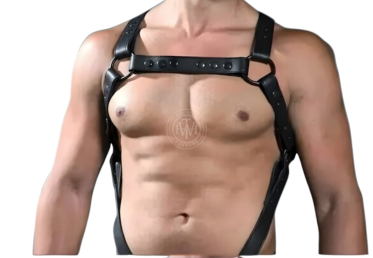 men's full-body leather harness with attached jockstrap, close-up of black leather harness chest bar with rivets, black o-rings and shoulder straps
