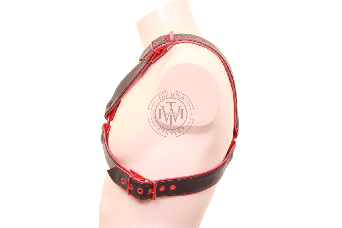 leather x harness styled with red studs and buckles