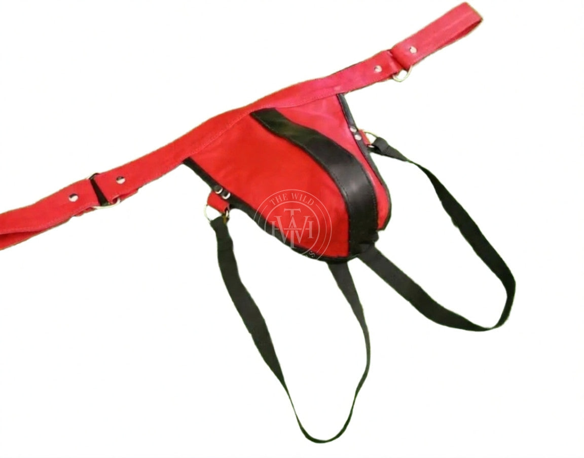 premium gay leather jockstrap, angled view of red leather jockstrap with black stripe pouch, hip rings and elastic leg bands
