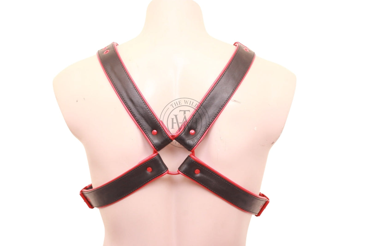 leather x harness styled with red studs and buckles