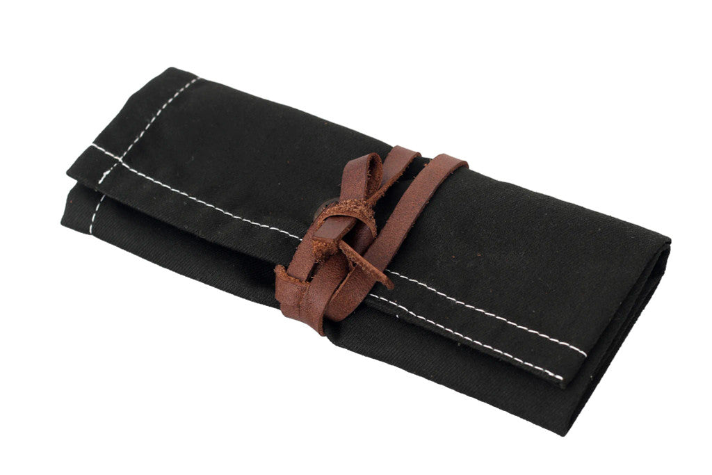 Black canvas tool roll, foldable storage pouch, roll-up tool bag, canvas utility roll, leather strap closure pouch, compact tool organizer, handmade tool holder, artisan tool wrap, canvas pouch with leather tie, heavy-duty canvas tool roll, cotton canvas storage case, durable fabric tool organizer, multi-pocket tool roll, portable tool wrap, hand tool storage pouch, tool kit roll for professionals, brush or tweezer roll case, minimalist tool pouch, rustic style tool roll, black pouch with white stitching,